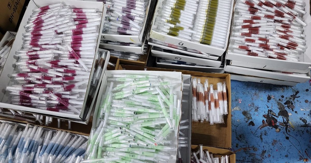 Pen-format water-based nail polish production, shades sorted in trays